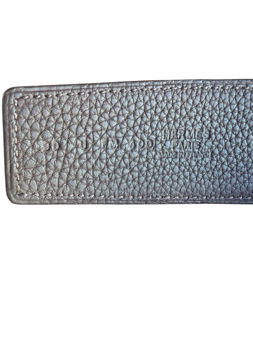 Studio444 HERMÈS leather belt featuring embossed branding and detailed stitching on textured black leather.